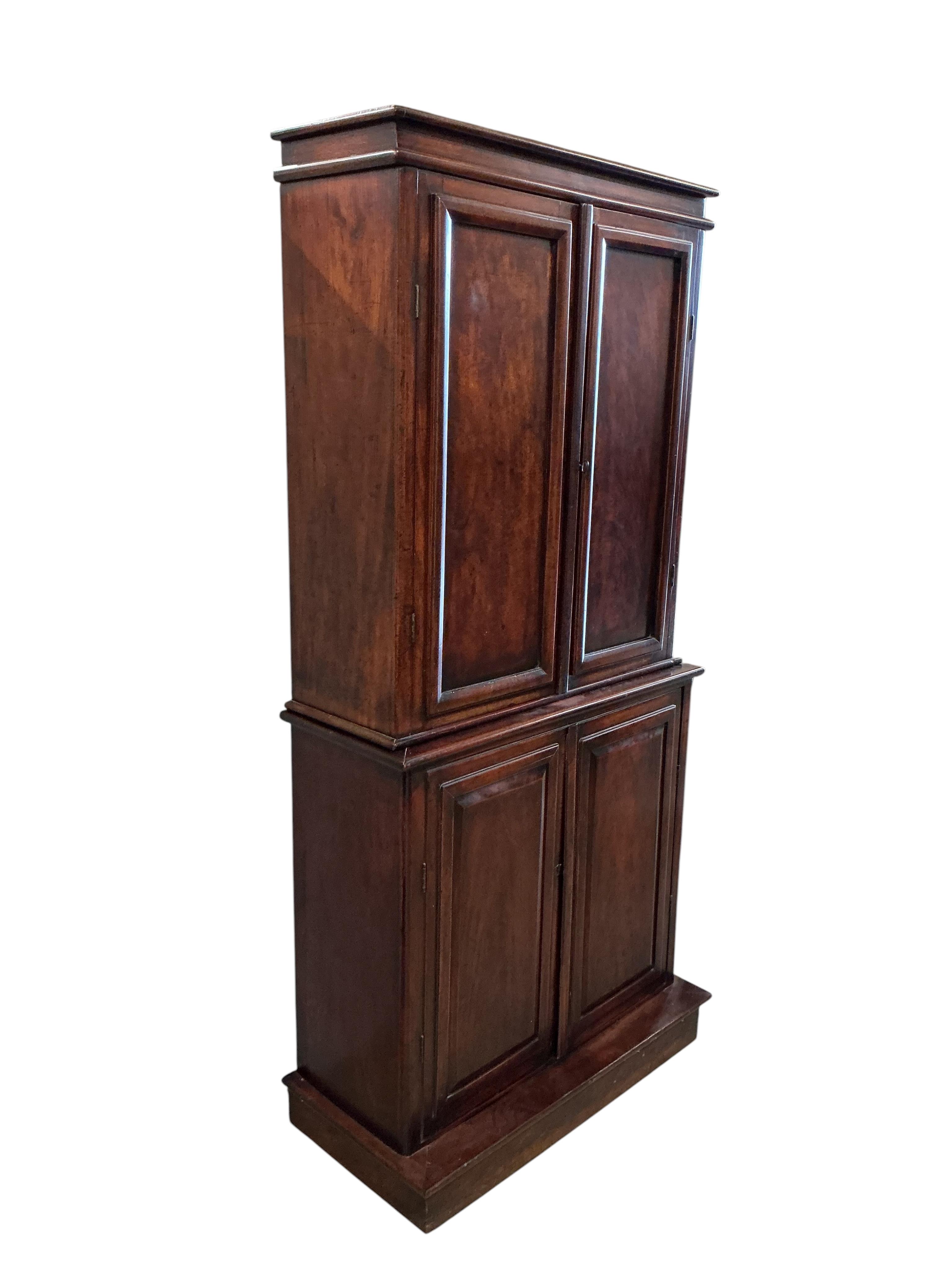 An early Victorian mahogany household cupboard, width 89cm, depth 35cm, height 187cm